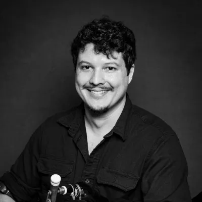 Mark Solters. A black-and-white portrait; the keys of a set of pipes are visible at the lower left.

